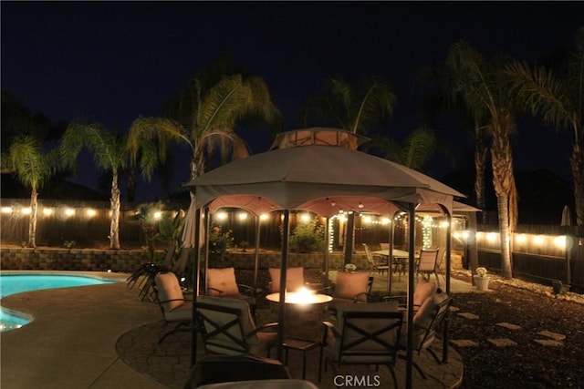 2653 Ashcroft Ave, Clovis, CA 93611 - patio at twilight with a gazebo, a fenced backyard, and a fenced in pool