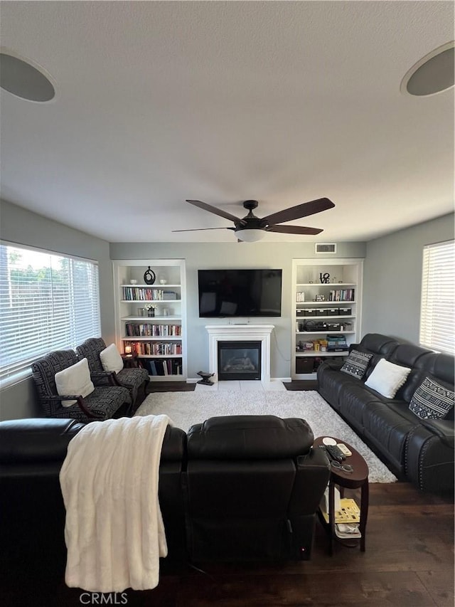 2653 Ashcroft Ave, Clovis, CA 93611 - living room featuring a ceiling fan, visible vents, built in features, and a healthy amount of sunlight