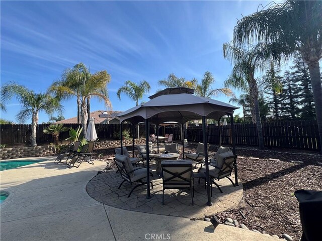 2653 Ashcroft Ave, Clovis, CA 93611 - view of patio featuring outdoor dining space, a gazebo, a community pool, and a fenced backyard