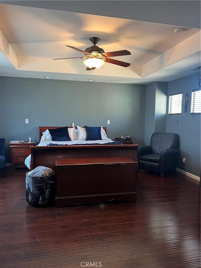 2653 Ashcroft Ave, Clovis, CA 93611 - bedroom featuring baseboards, a ceiling fan, dark wood-type flooring, and a tray ceiling