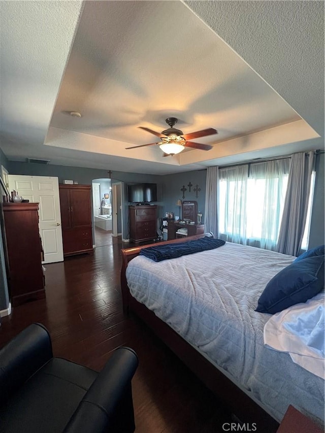 2653 Ashcroft Ave, Clovis, CA 93611 - bedroom featuring a textured ceiling, wood finished floors, a ceiling fan, and a tray ceiling