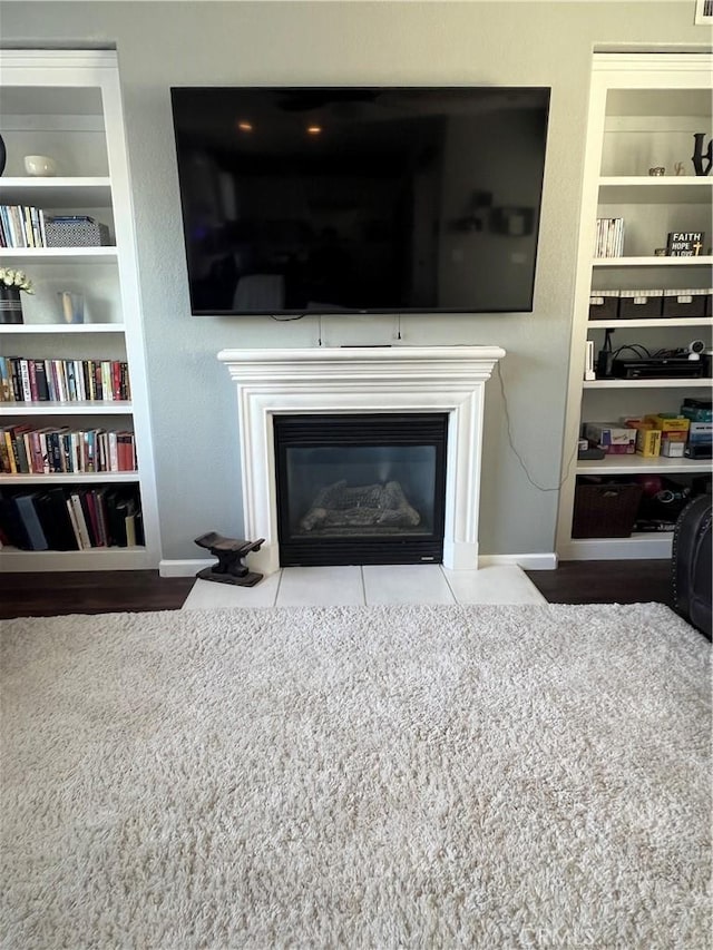 2653 Ashcroft Ave, Clovis, CA 93611 - details featuring baseboards, built in shelves, and a fireplace with flush hearth