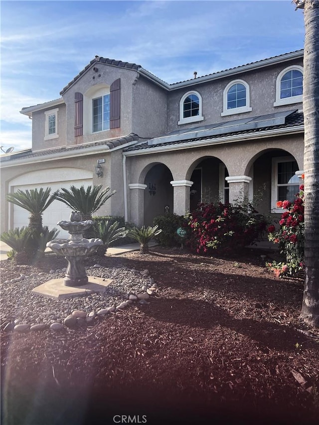 2653 Ashcroft Ave, Clovis, CA 93611 - view of front facade with stucco siding, a garage, a porch, and a tile roof