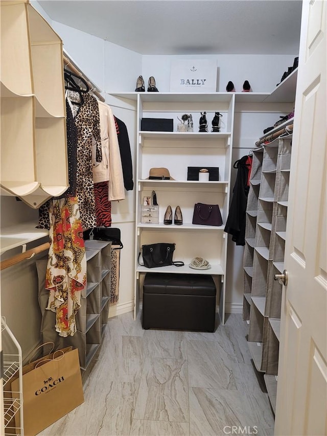 spacious closet with marble finish floor