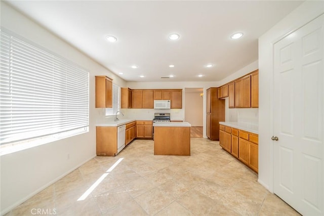 36877 Meadow Brook Way, Beaumont, CA 92223 - kitchen with white appliances, a sink, light countertops, recessed lighting, and a center island