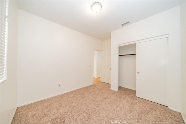 36877 Meadow Brook Way, Beaumont, CA 92223 - unfurnished bedroom with light colored carpet, a closet, and baseboards