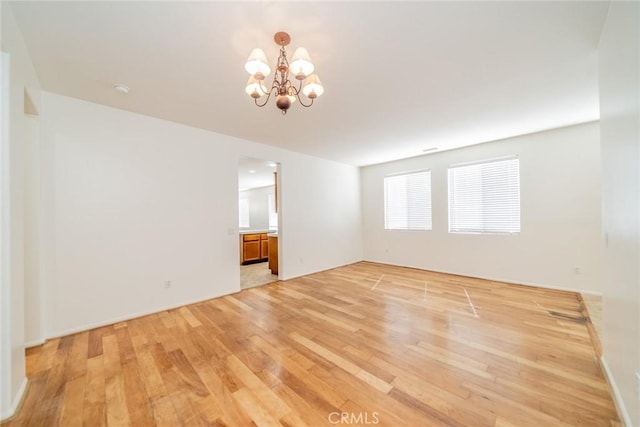36877 Meadow Brook Way, Beaumont, CA 92223 - empty room with a chandelier and light wood-style floors