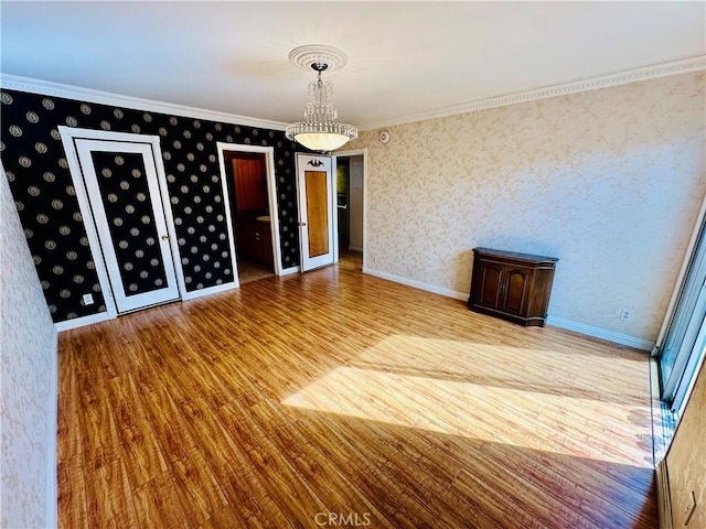 6225 Coldwater Canyon Ave Unit 117, North Hollywood, CA 91606 - unfurnished dining area featuring baseboards, ornamental molding, wood finished floors, and wallpapered walls