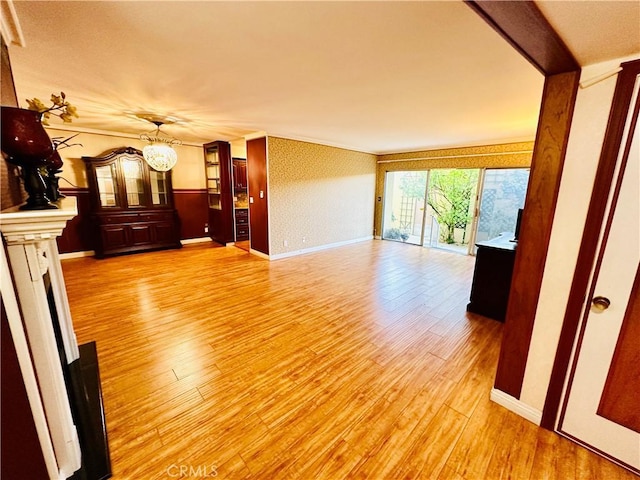 6225 Coldwater Canyon Ave Unit 117, North Hollywood, CA 91606 - unfurnished living room featuring a chandelier, light wood-type flooring, and baseboards