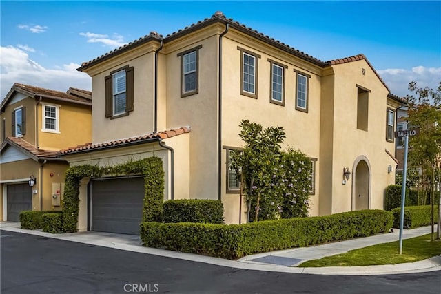 109 Baculo St, Rancho Mission Viejo, CA 92694 - view of front of home with stucco siding, an attached garage, and a tile roof