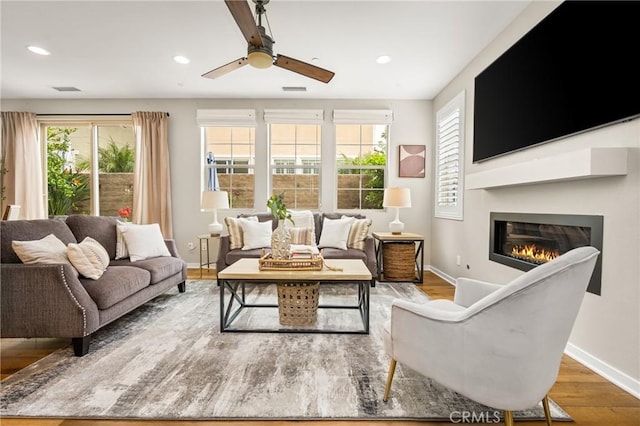 109 Baculo St, Rancho Mission Viejo, CA 92694 - living area with wood finished floors, baseboards, ceiling fan, and a healthy amount of sunlight