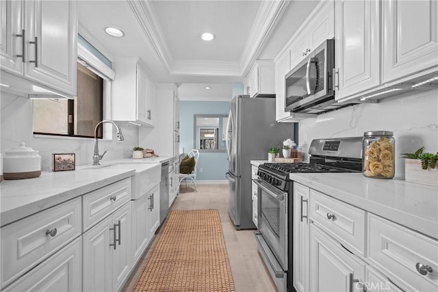 2357 Palos Verdes Dr W Unit 3, Palos Verdes Estates, CA 90274 - kitchen featuring a sink, stainless steel appliances, crown molding, white cabinets, and a raised ceiling
