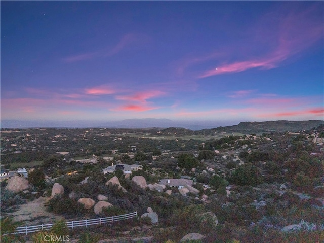 aerial view at dusk featuring a mountain view