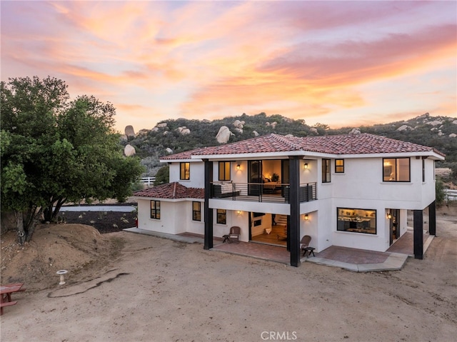 41950 Hacienda Dr, Murrieta, CA 92562 - rear view of house with a balcony, stucco siding, and a patio