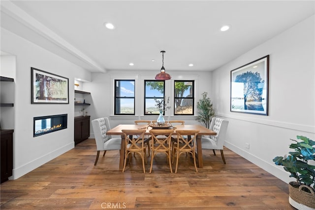 41950 Hacienda Dr, Murrieta, CA 92562 - dining area with a glass covered fireplace, recessed lighting, wood finished floors, built in features, and baseboards