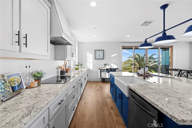 kitchen featuring a sink, dishwashing machine, premium range hood, black electric stovetop, and light wood-style floors