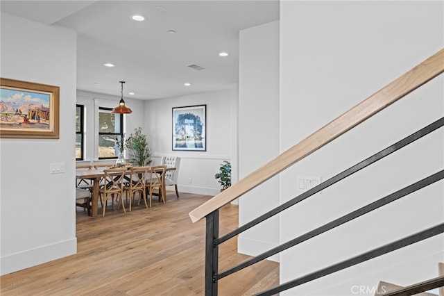 staircase with baseboards, recessed lighting, wood finished floors, and visible vents