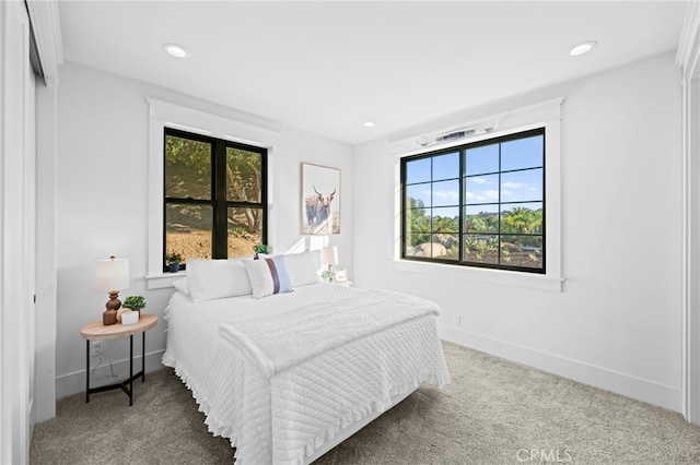 bedroom featuring carpet floors, recessed lighting, and multiple windows