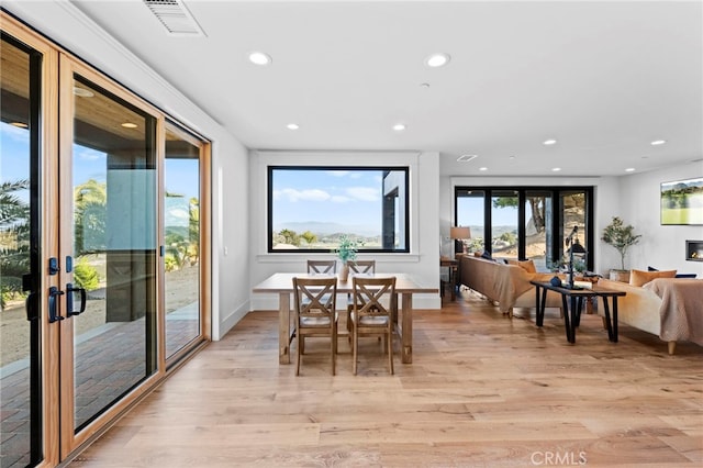 dining space featuring visible vents, light wood-style floors, baseboards, recessed lighting, and french doors