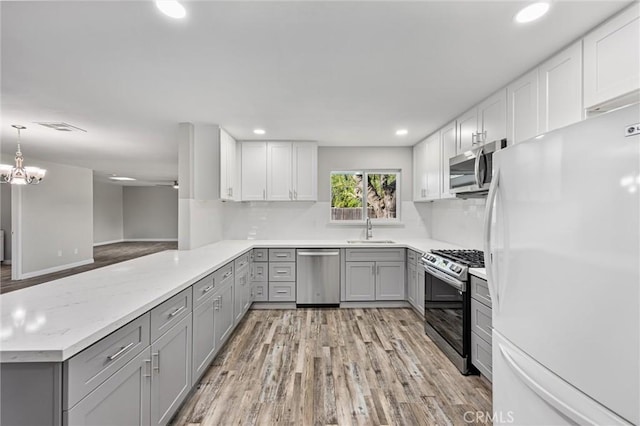 513 River Oaks Dr, Bakersfield, CA 93309 - kitchen featuring appliances with stainless steel finishes, gray cabinetry, a sink, and visible vents