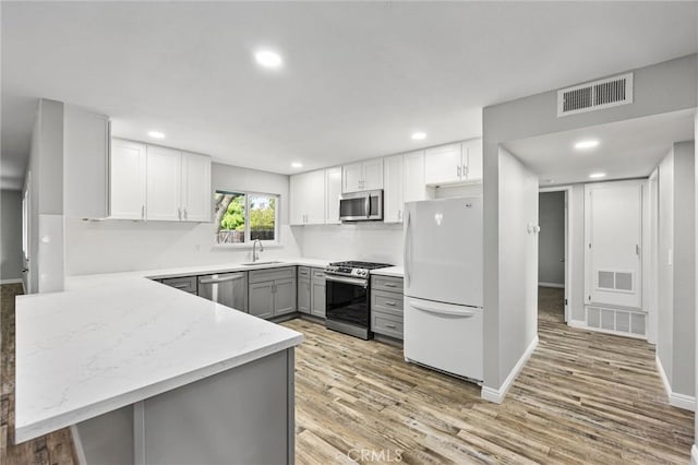 513 River Oaks Dr, Bakersfield, CA 93309 - kitchen featuring gray cabinetry, stainless steel appliances, visible vents, and a sink