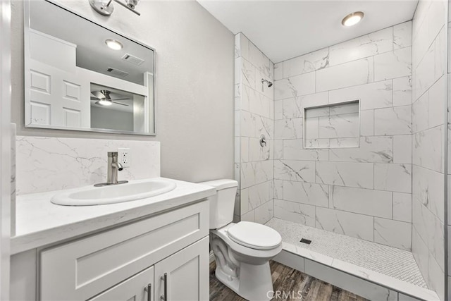 513 River Oaks Dr, Bakersfield, CA 93309 - bathroom featuring visible vents, toilet, vanity, decorative backsplash, and tiled shower