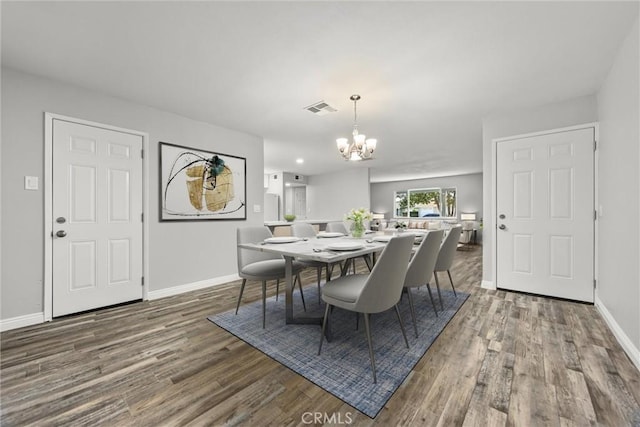 513 River Oaks Dr, Bakersfield, CA 93309 - dining area featuring baseboards, wood finished floors, a chandelier, and visible vents