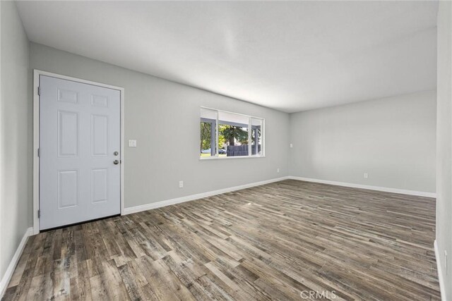 513 River Oaks Dr, Bakersfield, CA 93309 - unfurnished living room with baseboards and wood finished floors