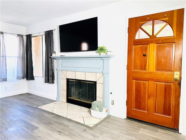 22703 Copper Hill Dr Unit 2, Saugus, CA 91350 - unfurnished living room featuring plenty of natural light, baseboards, and wood finished floors
