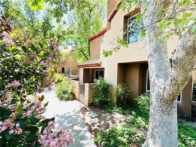 22703 Copper Hill Dr Unit 2, Saugus, CA 91350 - view of side of property featuring a tile roof and stucco siding