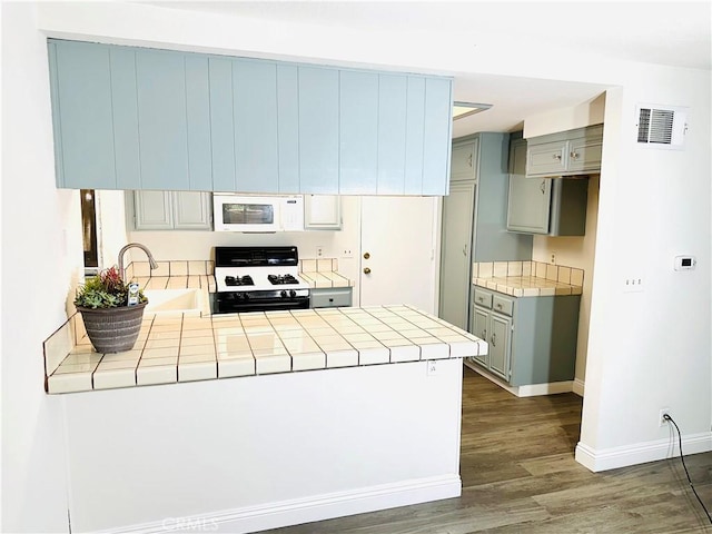 22703 Copper Hill Dr Unit 2, Saugus, CA 91350 - kitchen featuring a peninsula, gray cabinetry, white appliances, and tile countertops