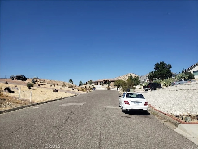 16389 Viho Ct, Apple Valley, CA 92307 - view of asphalt road with curbs and a residential view
