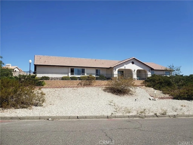 single story home with fence private yard, a tile roof, and stucco siding