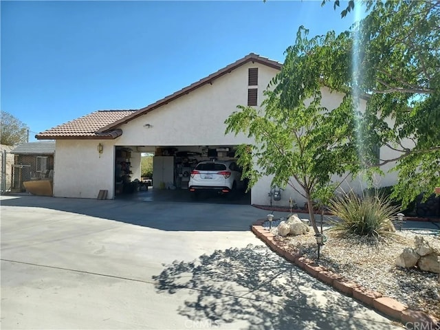16389 Viho Ct, Apple Valley, CA 92307 - view of front of house with stucco siding, concrete driveway, a tiled roof, and a garage