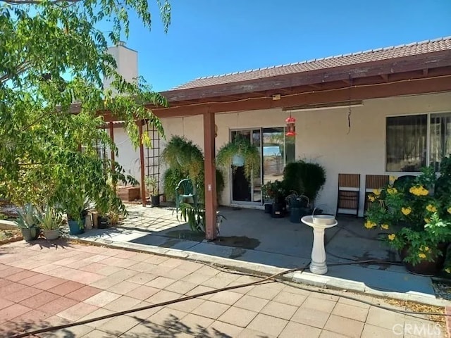 16389 Viho Ct, Apple Valley, CA 92307 - rear view of property with a patio area, stucco siding, and a chimney