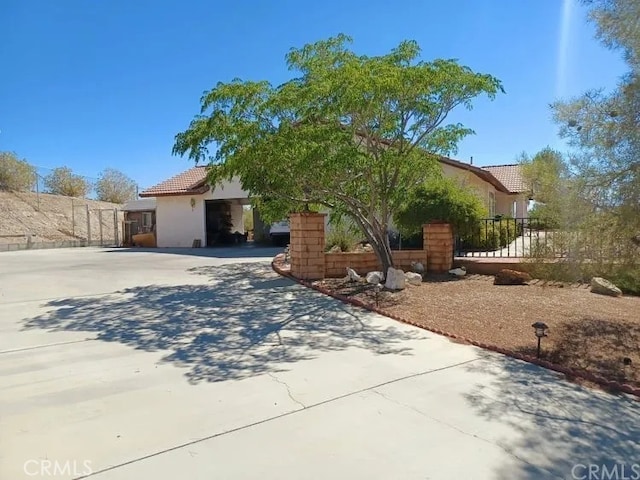 16389 Viho Ct, Apple Valley, CA 92307 - obstructed view of property featuring a tiled roof, stucco siding, and driveway