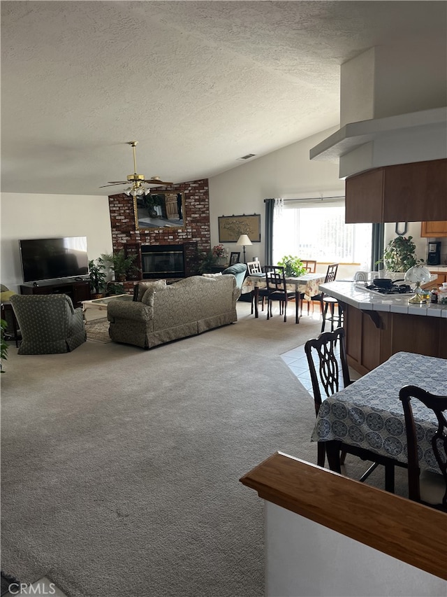 16389 Viho Ct, Apple Valley, CA 92307 - carpeted living room with a brick fireplace, a textured ceiling, and a ceiling fan