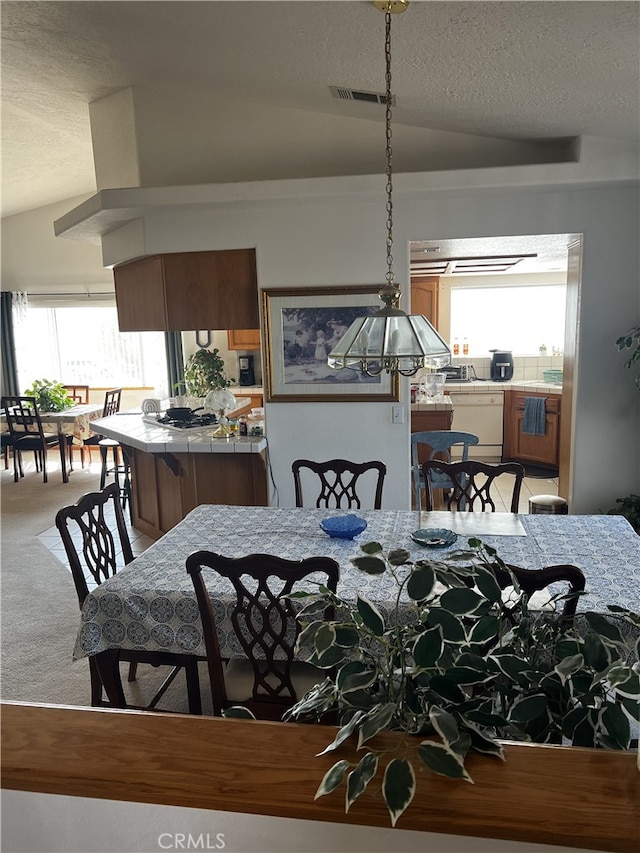 16389 Viho Ct, Apple Valley, CA 92307 - dining space featuring light colored carpet, a textured ceiling, and lofted ceiling