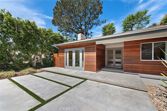 3120 Bern Dr, Laguna Beach, CA 92651 - back of property with french doors and a chimney