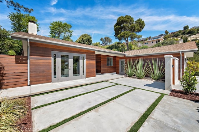 3120 Bern Dr, Laguna Beach, CA 92651 - back of property with french doors, a patio, and a chimney