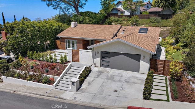 3120 Bern Dr, Laguna Beach, CA 92651 - view of front of house featuring stairs, concrete driveway, a garage, stucco siding, and a chimney
