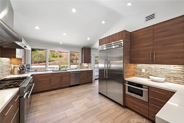 3120 Bern Dr, Laguna Beach, CA 92651 - kitchen with premium appliances, island exhaust hood, modern cabinets, decorative backsplash, and vaulted ceiling