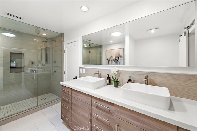 3120 Bern Dr, Laguna Beach, CA 92651 - bathroom featuring a stall shower, double vanity, decorative backsplash, tile patterned floors, and recessed lighting