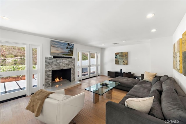 3120 Bern Dr, Laguna Beach, CA 92651 - living room featuring a fireplace, recessed lighting, light wood-style flooring, and french doors