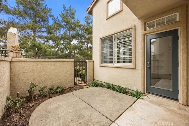 view of patio / terrace featuring a gate and fence