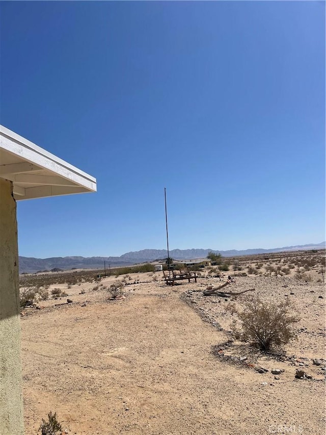 view of yard featuring a rural view, a desert view, and a mountain view