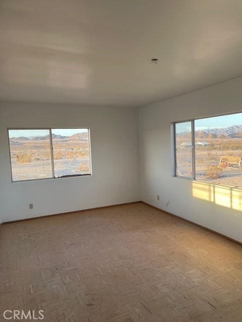 spare room with baseboards