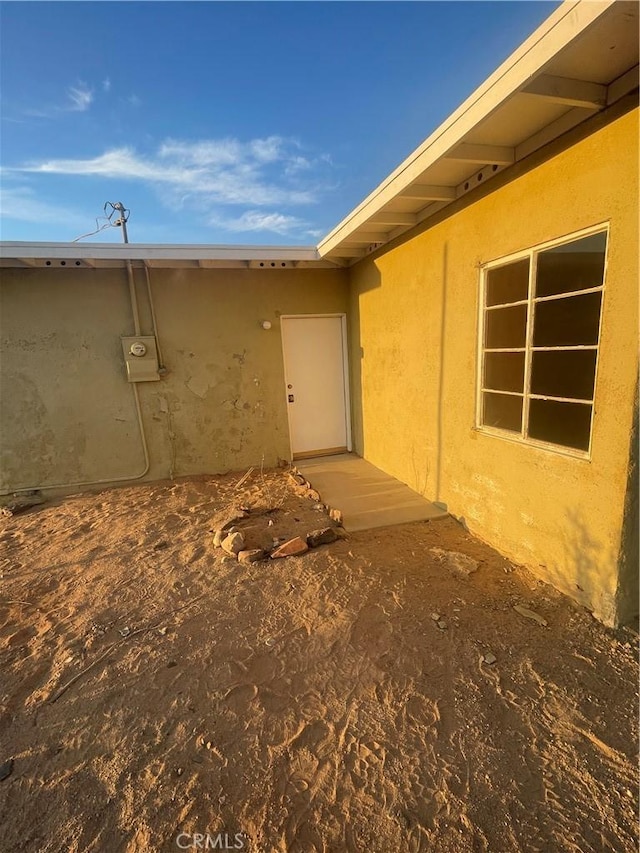 entrance to property featuring stucco siding