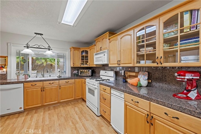 21643 Spice Ct, Saugus, CA 91350 - kitchen featuring white appliances, backsplash, light wood-style floors, and glass insert cabinets