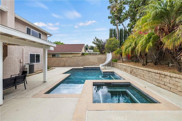 21643 Spice Ct, Saugus, CA 91350 - view of pool with a water slide, an in-ground hot tub, a patio, and a fenced backyard
